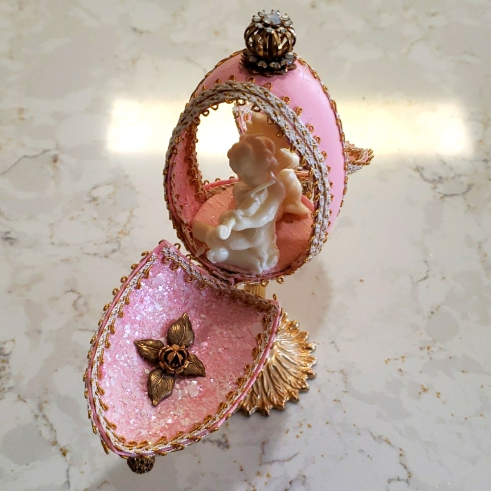 Decorative embellished egg with cherubs inside